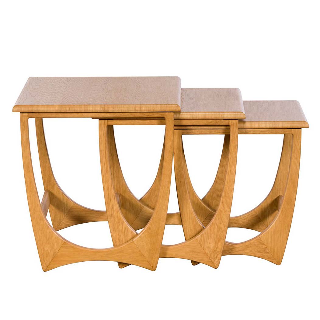 The set of three oak tables arranged in a staggered line to display the graduated heights and sizes.