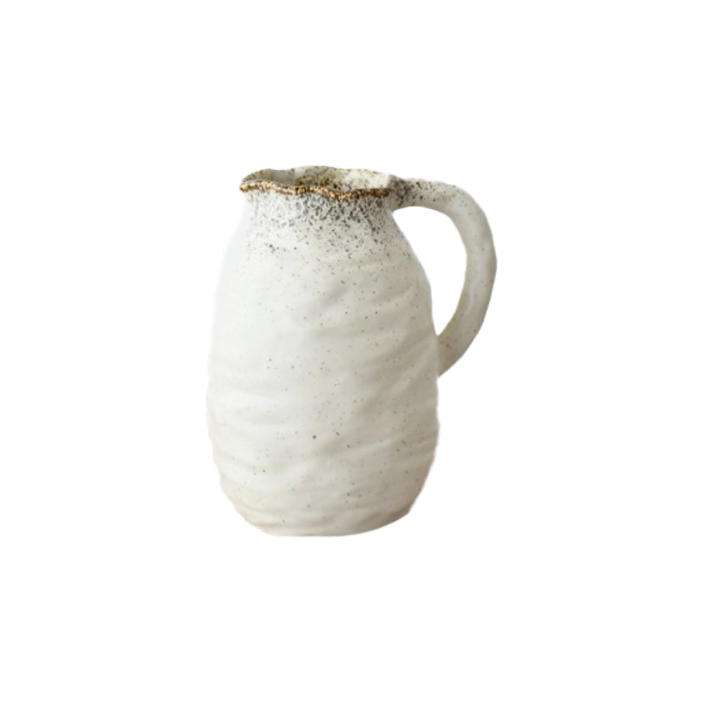 Off-white Beba jug with a tactile ridged surface, grey speckled rim, and a curved handle against a white background.