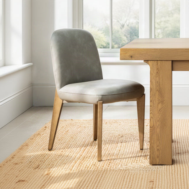 Maddison Dining Chair in Misty grey faux leather styled by a natural oak dining table