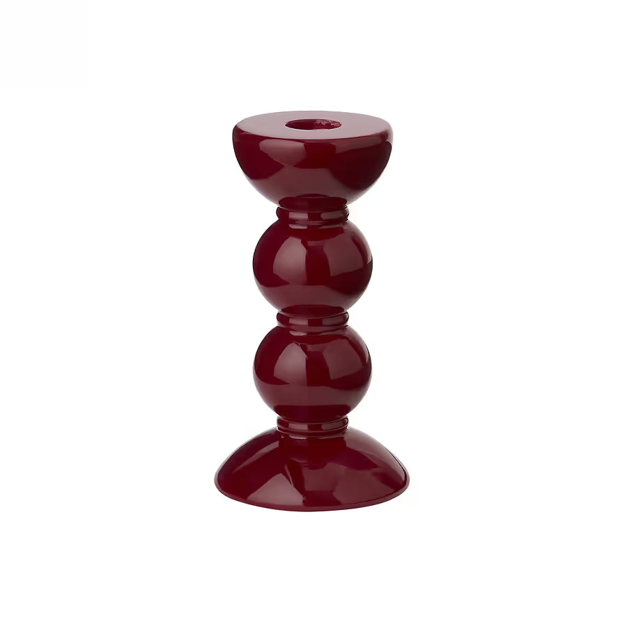 Small bobbin candlestick in high-gloss cherry red showing the turned silhouette and mirror-like shine.