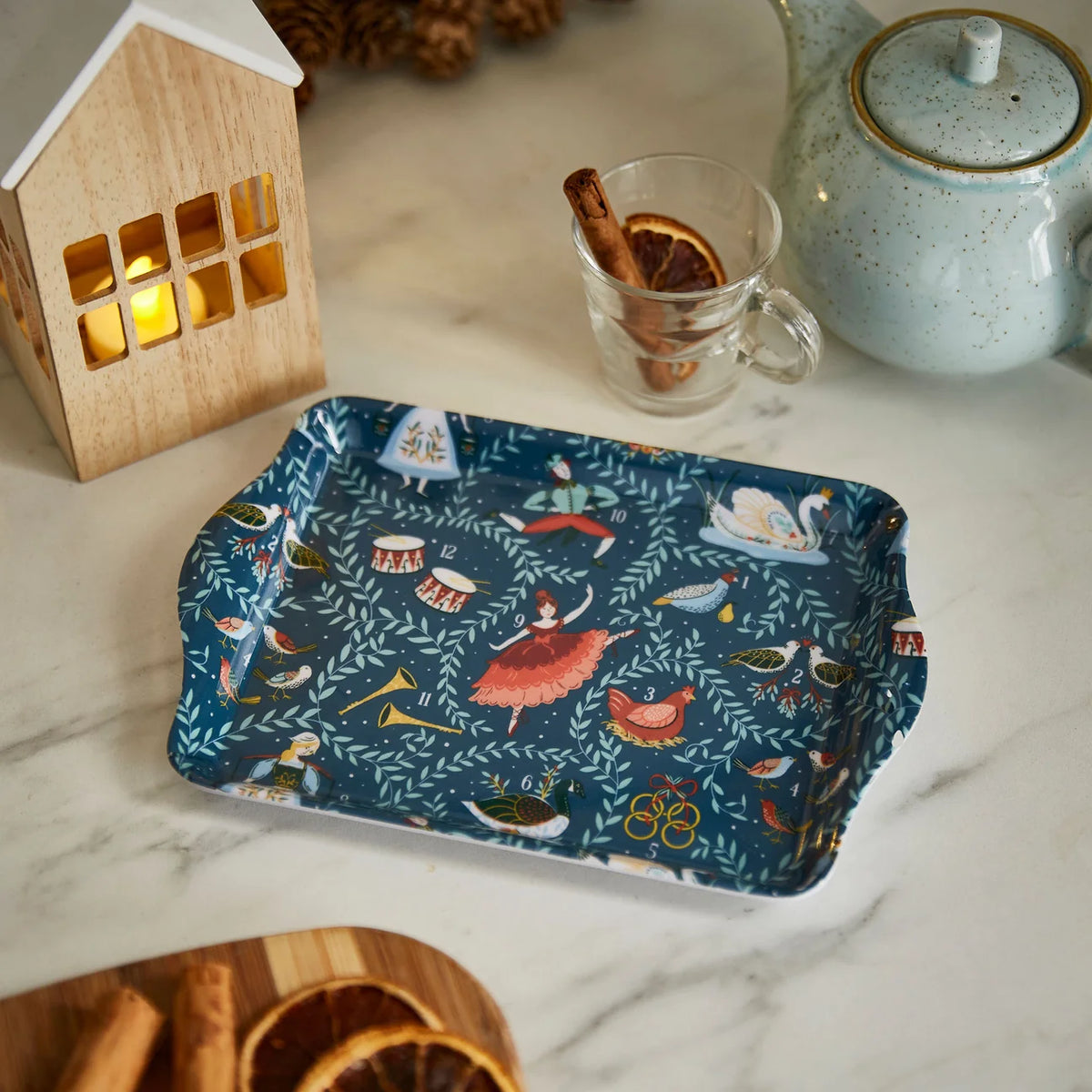Small 12 Days of Christmas tray styled on a kitchen counter with a teapot and festive decorations