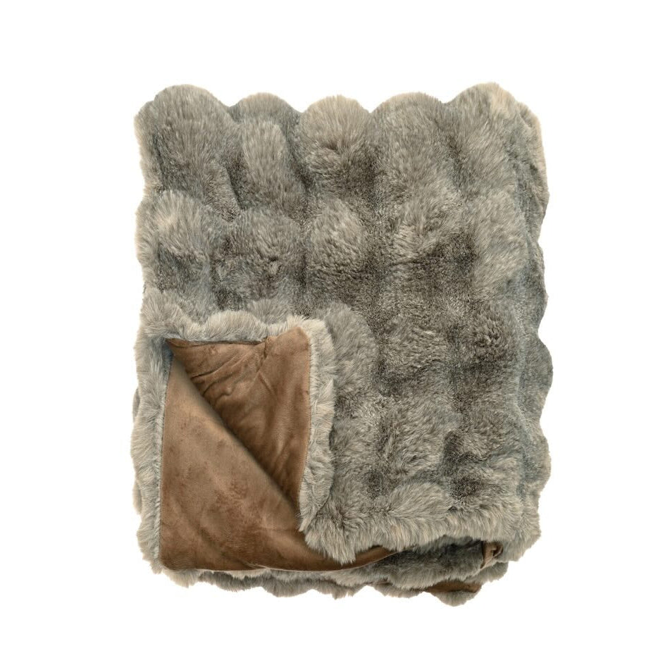 Folded brown faux fur throw showing the textured sheared surface and smooth tonal reverse backing.