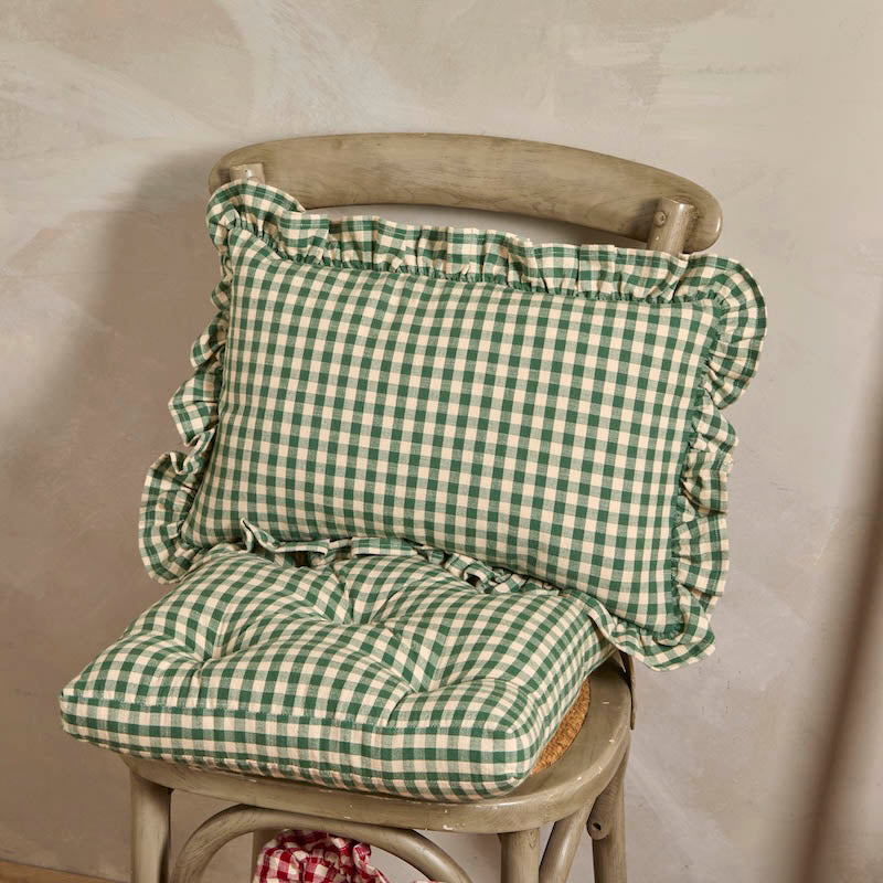 Foliage green gingham linen cushion styled on a wooden chair alongside a matching seat pad.