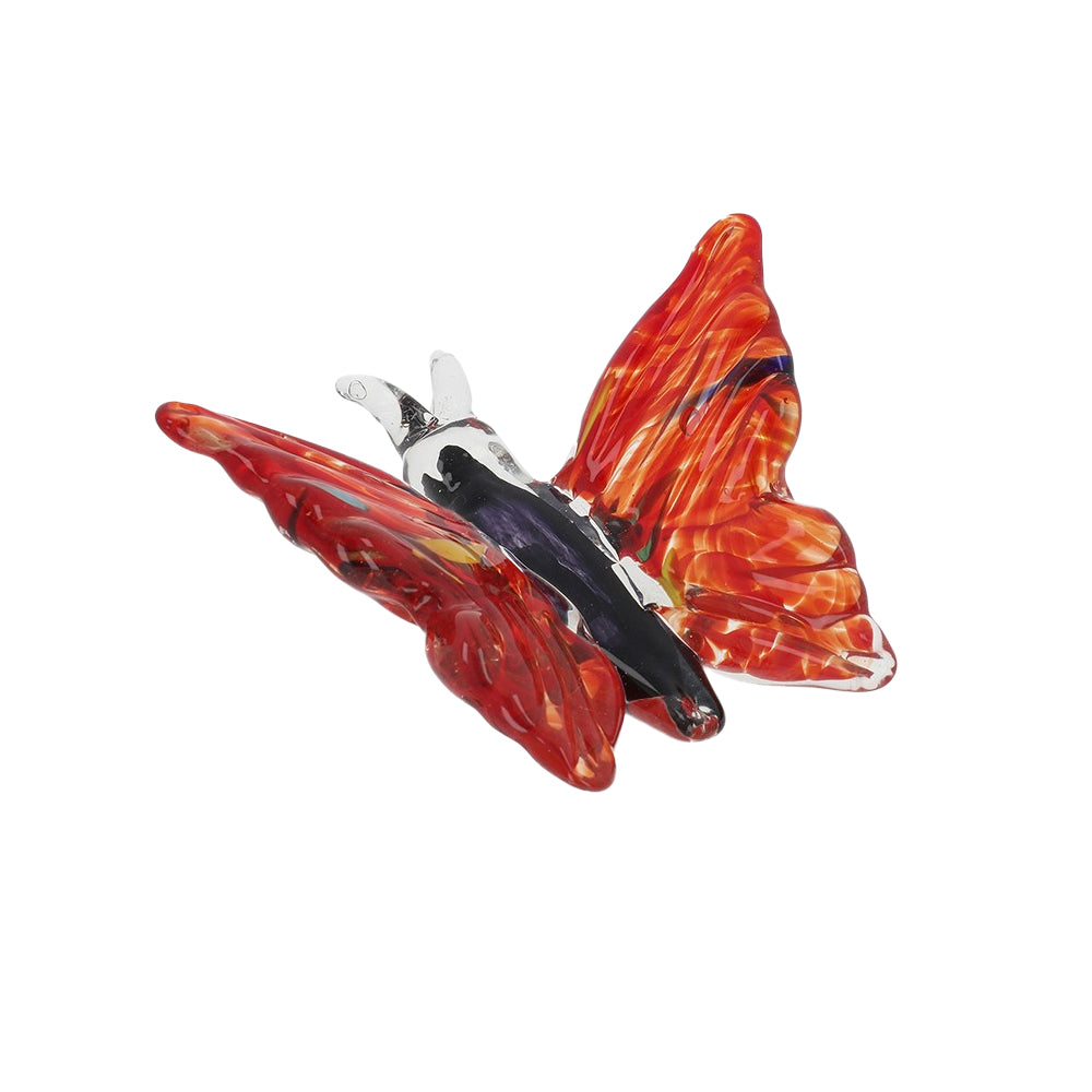Handmade glass butterfly with vibrant red marbled wings and a dark body, viewed from above on a white background