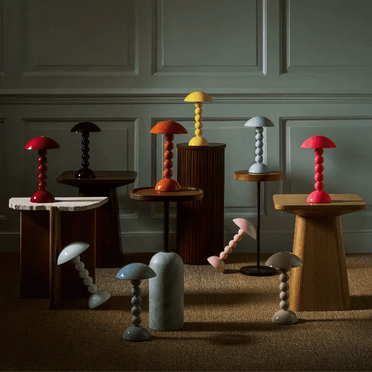 A collection of bobbin lamps in various colours including red, yellow, pink, and blue