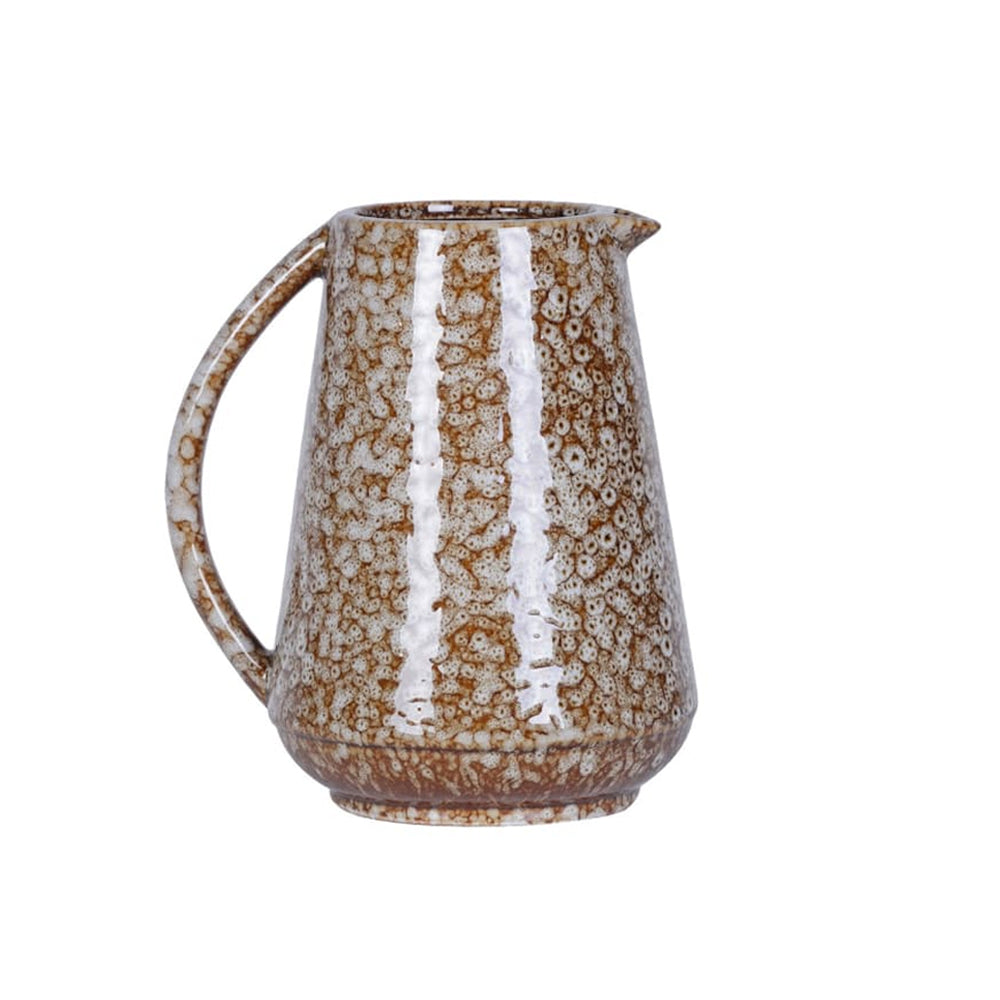 Side profile of a tapered slip glaze jug showing the curved handle and textured stoneware surface