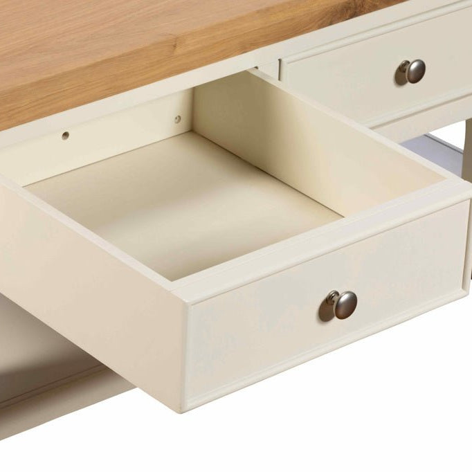 Close-up of an open storage drawer on the white painted coffee table showing the smooth interior