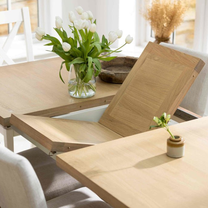 The butterfly leaf extension mechanism being opened on the Burford dining table