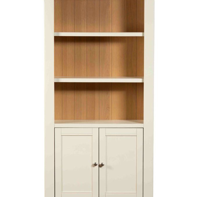 Straight-on front view of the Burford storage bookcase featuring three shelves and a two-door cupboard