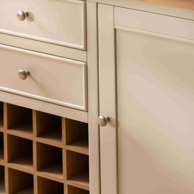 Close-up of the white painted finish and silver knobs on the sideboard drawers
