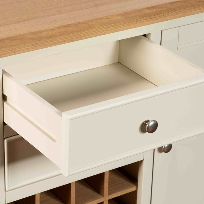 Open drawer of the white sideboard showing the smooth interior and silver handle