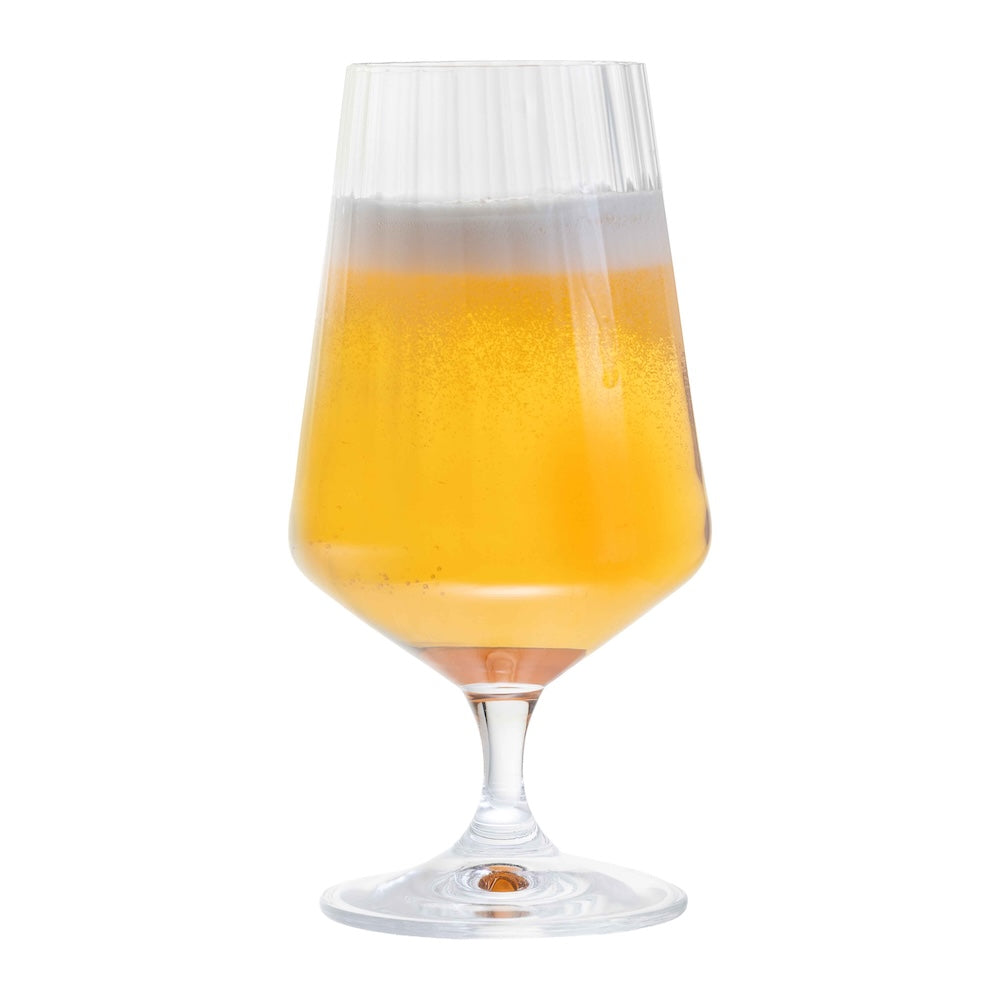 A single Dartington Cheers! Optic Small Beer Glass filled with lager and a thick foam head.