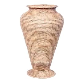 Tapered natural rattan pot with a pedestal base and wide rim against a white background.