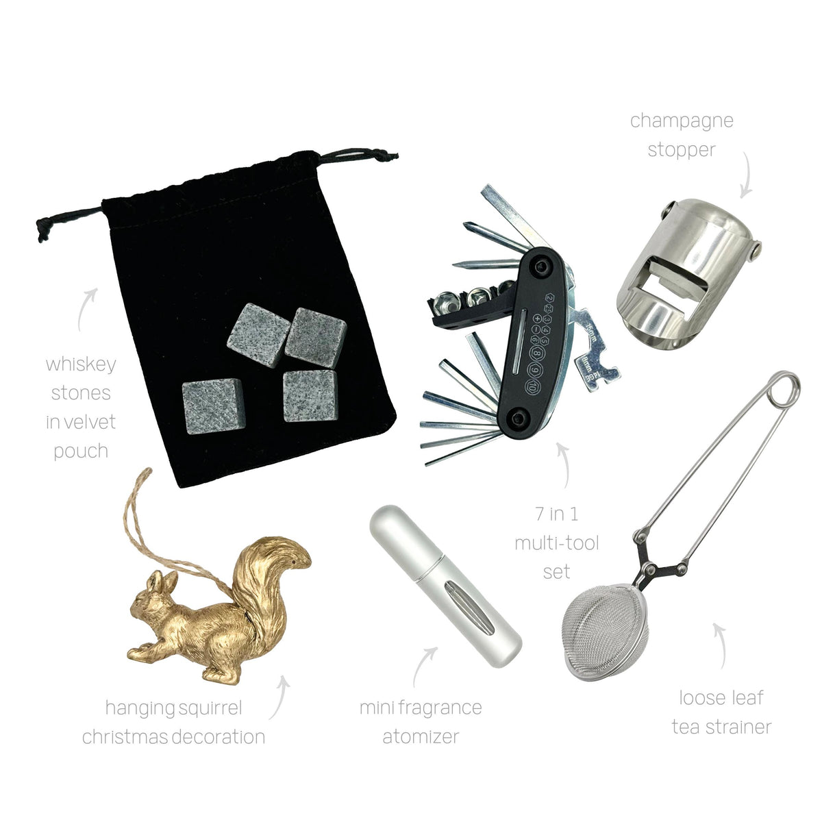Luxury cracker gifts including whiskey stones, tea strainer, multi-tool, and gold squirrel decoration.