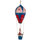 Hand-painted metal Christmas decoration featuring Santa in a blue and red hot air balloon with gold stars