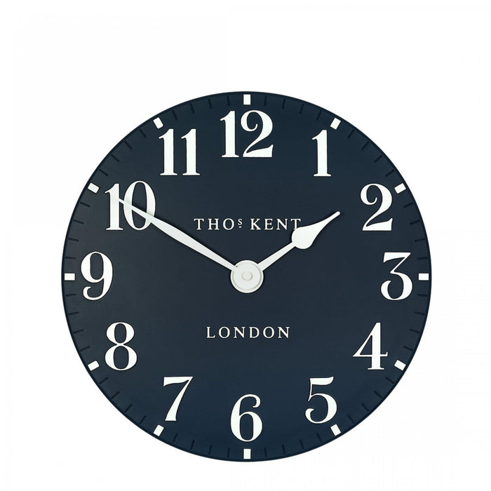 Circular 12-inch wall clock with inky blue face, white Arabic numerals, and white hands.