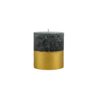 Winter Thyme pillar candle with dark grey-green wax and a shimmering gold-dipped lower half.