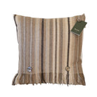 Square merino wool cushion with vertical neutral stripes, decorative buttons and a fringed bottom edge.