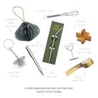 Selection of luxury cracker gifts including a bee keyring, metal straw, wooden puzzle, and mini whisk.