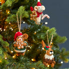 Handmade felt animal decorations including Harvey the Hamster hanging on a lit Christmas tree.