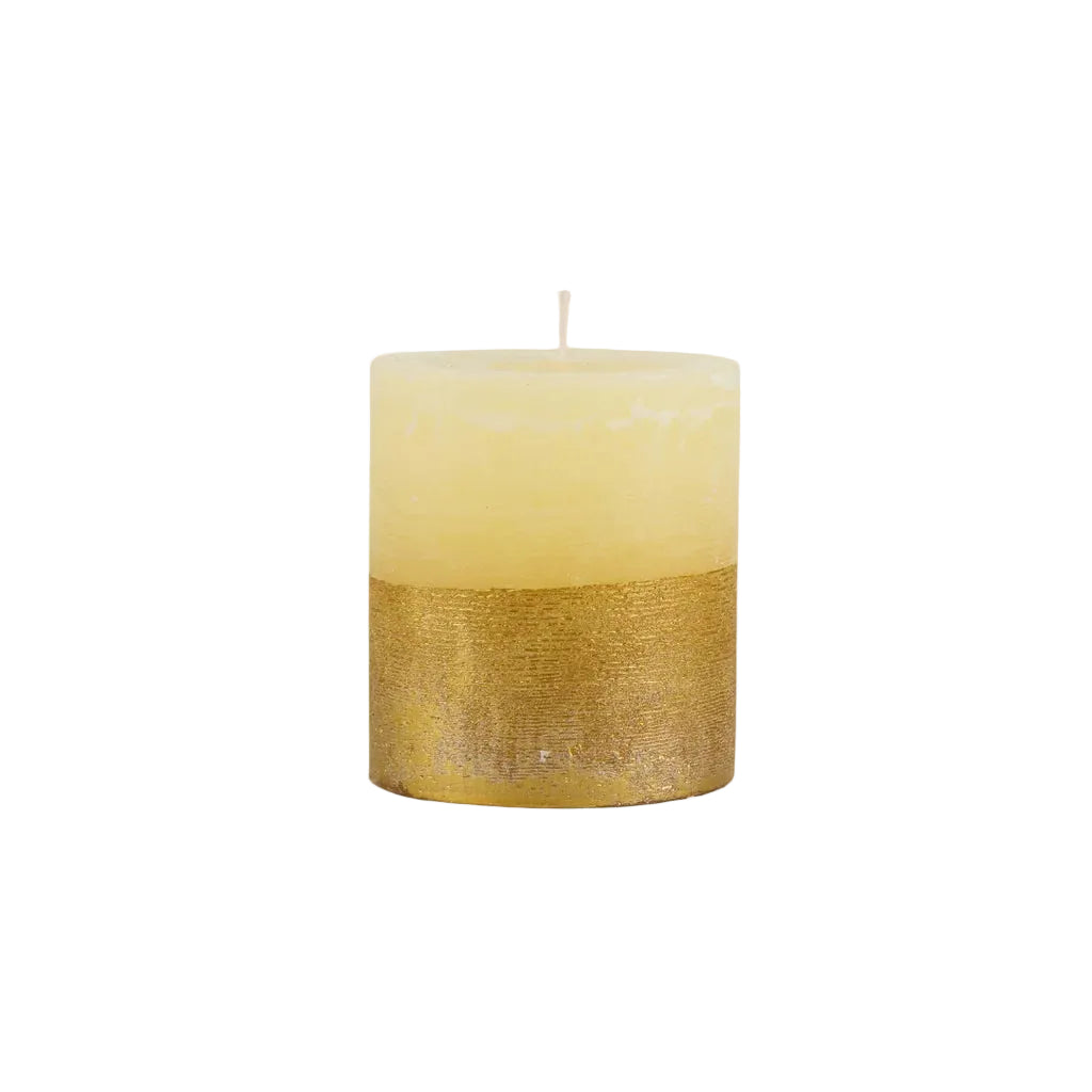 Gold-dipped cream pillar candle with a textured metallic base on a white background.