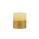 Gold-dipped cream pillar candle with a textured metallic base on a white background.
