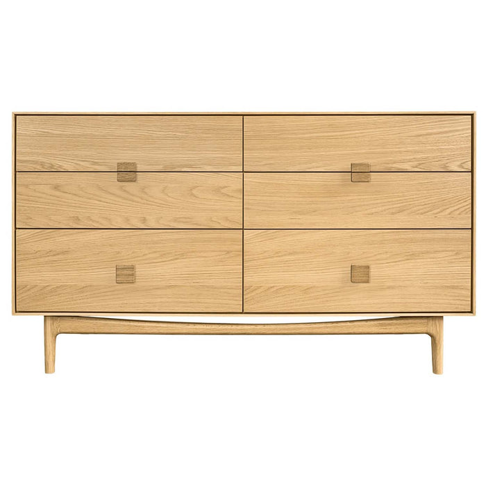 Front view of a light oak 6 drawer wide chest with signature square handles and tapered legs