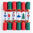 Set of six festive crackers lined up showing Nutcracker, Mouse King, and Christmas tree designs.