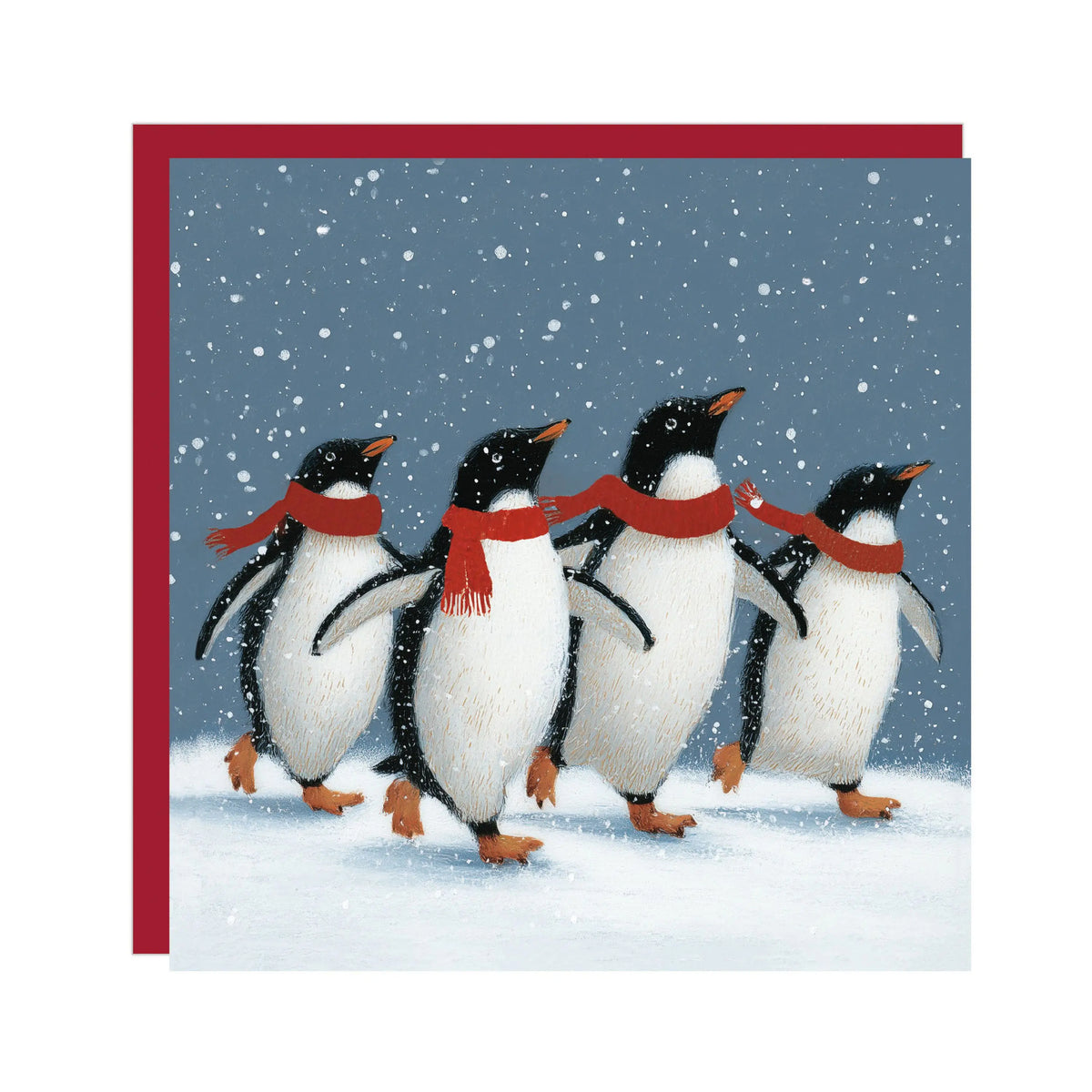 Illustrated Christmas card showing four penguins in red scarves walking in the snow with a red envelope behind.