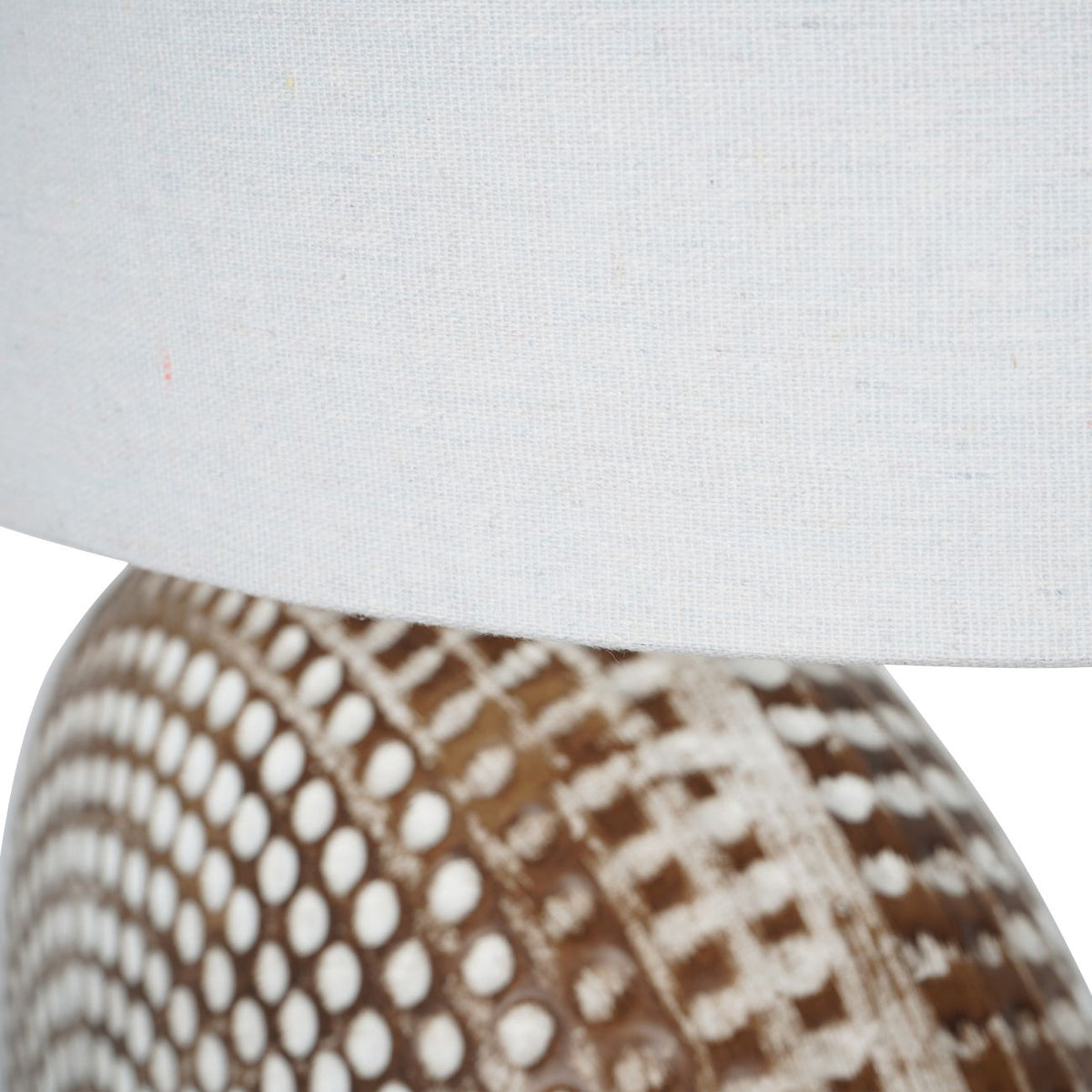 Detail shot of the ivory natural linen fabric shade and the chrome bulb fixture