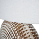 Detail shot of the ivory natural linen fabric shade and the chrome bulb fixture