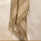 Close-up of the birch stripe wool blend throw draped to show texture and fringing