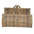 Side profile of the rattan log basket showing its curved shape and woven texture