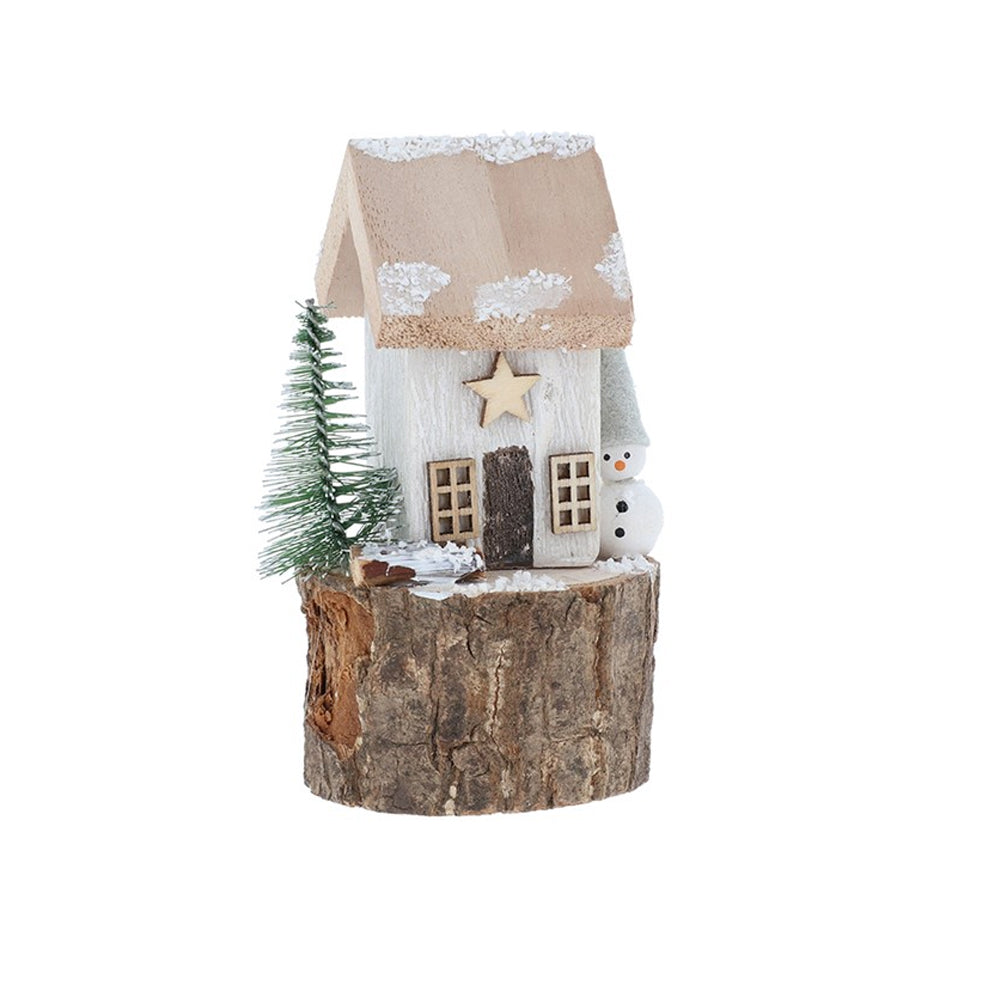 White wooden Christmas cottage featuring a wooden star and a snowman figure on a log plinth.