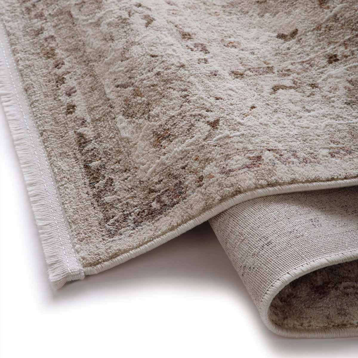 Close-up of the Aurelia Cream rug corner showing the short fringe and woven backing.