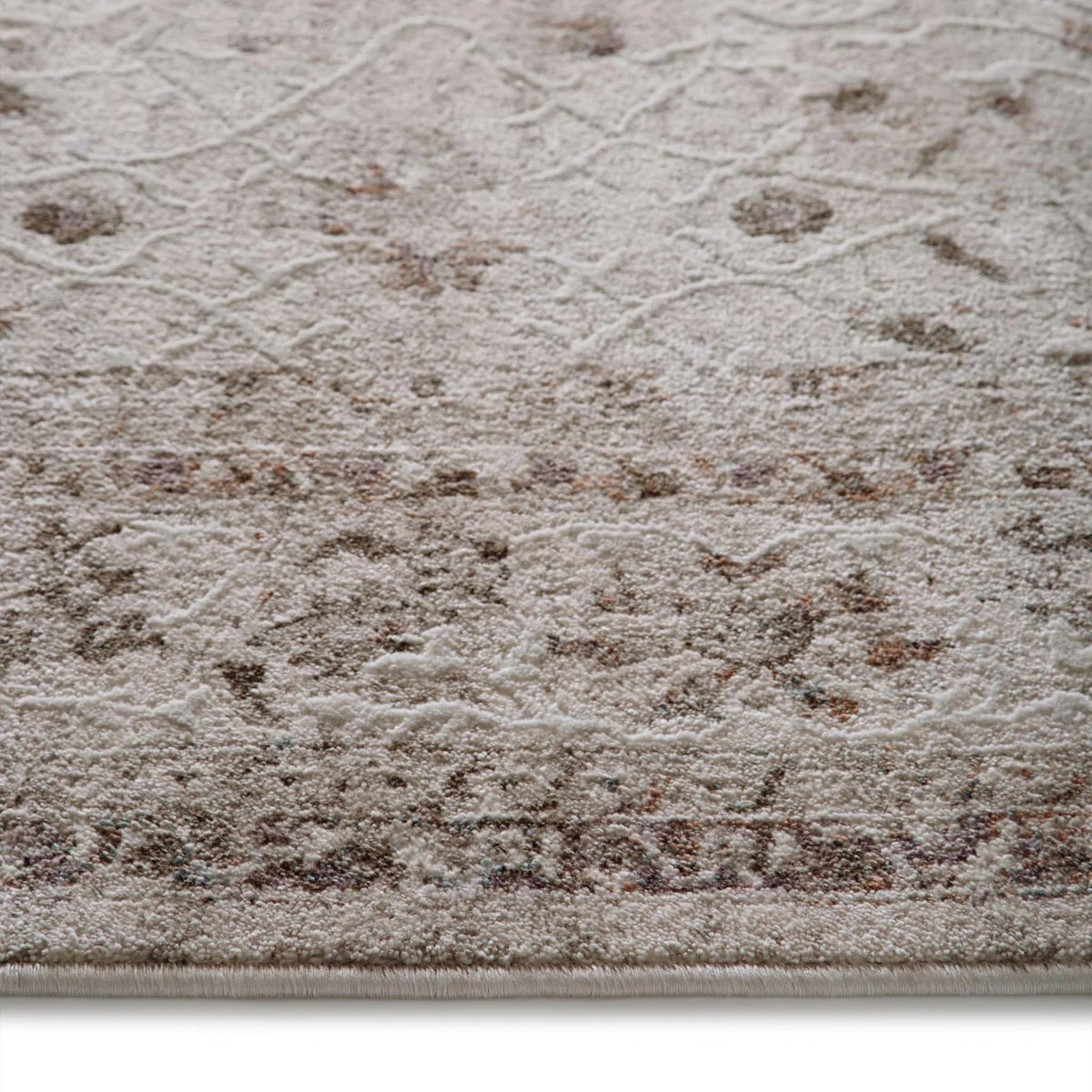 Close-up of the Aurelia Cream rug texture and floral print detailing on the durable polyester yarn.