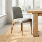 Maddison Dining Chair in Misty grey faux leather styled by a natural oak dining table