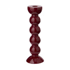 High-gloss cherry red bobbin candlestick showing the deep glass-like shine and turned wood design.