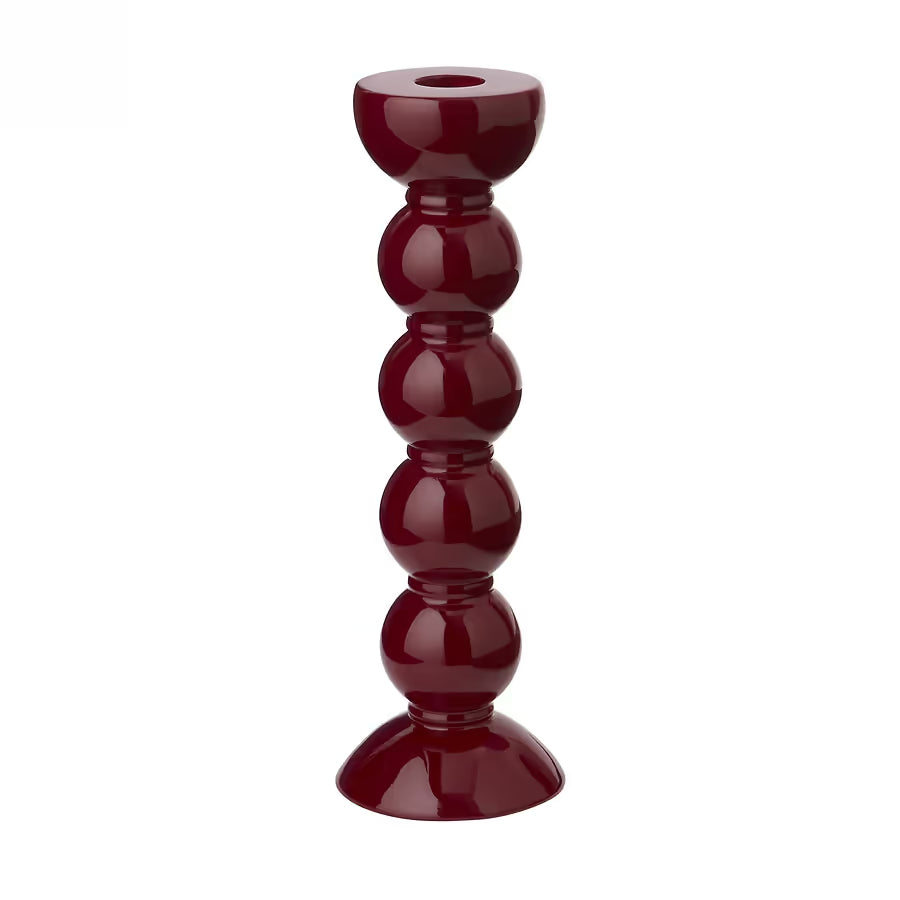 High-gloss cherry red bobbin candlestick showing the deep glass-like shine and turned wood design.