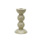 Small bobbin-shaped candlestick in high-gloss cappuccino lacquer against a plain white background