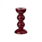 Small bobbin candlestick in high-gloss cherry red showing the turned silhouette and mirror-like shine.