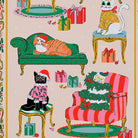 Close-up of cat illustrations on a tea towel including a black cat in a holly jumper and an orange tabby