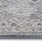 Close-up of the Celeste Sea Green rug texture showing the raised pile and distressed ivory floral details.