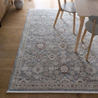 Celeste Sea Green rug styled in a dining room under a wooden table and chairs.