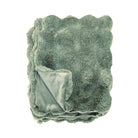 Folded eucalyptus green faux fur throw showing the soft textured surface and smooth lining