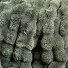 Close-up of the sheared faux fur texture showing the feather-like depth and eucalyptus green colour