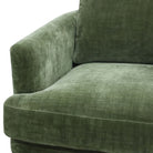 Close-up of the green velvet upholstery and armrest detail on the Florence chair