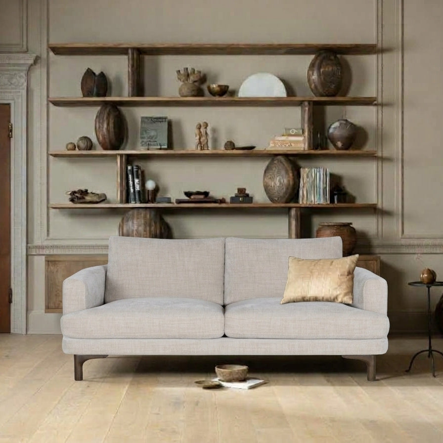 Florence 2-seat sofa in light beige fabric styled in a neutral living room with wooden shelving