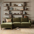 Front view of the olive green Florence corner sofa with left-hand chaise in a living room setting