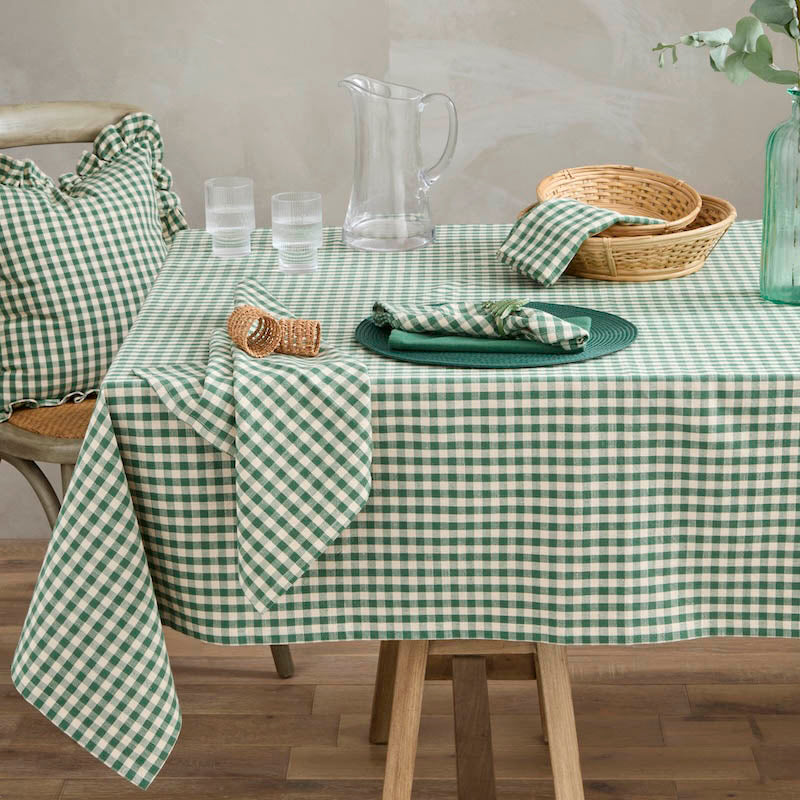 Lifestyle view of green gingham napkins and matching tablecloth styled on a wooden dining table
